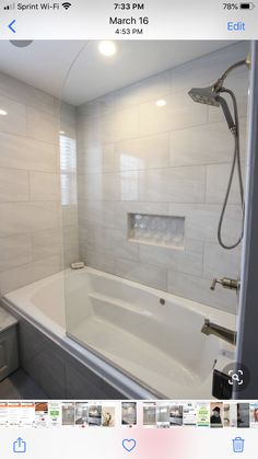 a white bath tub sitting inside of a bathroom