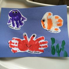 a child's handprinted paper with sea animals on it