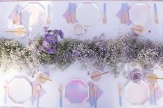 an overhead view of a table with plates, flowers and napkins on the table