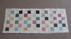 a patchwork table runner made from old quilts