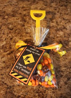 a bag filled with candy sitting on top of a counter next to a caution sign