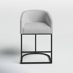 a gray chair sitting on top of a white floor next to a black metal frame