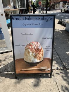 a sign on the sidewalk advertising some kind of dessert