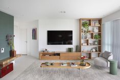 a living room filled with furniture and a flat screen tv