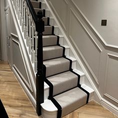 a staircase with carpeted steps leading up to the second floor