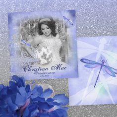 a blue flower is next to a card with a photo and dragonfly on it