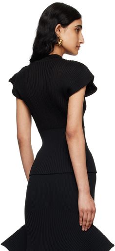 Rib knit polyester- and cupro-blend sweater. · Mock neck · Cap sleeves Supplier color: Black Chic Black Funnel Neck Sweater, Black High Neck Knit Top, Structured Evening Top For Fall, Evening Structured Top For Fall, Modern Black Textured Knit Top, Fitted Black Sweater With Funnel Neck, Black Stretch Knit Top For Workwear, Stretch Black Knit Top For Work, Black High-neck Knit Top For Layering