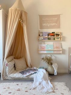 a room with a bed, dresser and shelves on the wall next to a baby's crib