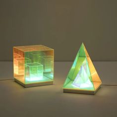 three different colored lamps sitting on top of a table