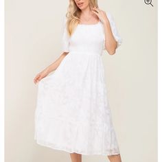 A Floral Textured Midi With A Smocked Bodice, Ruffle Accent Squared Neckline, And Short Puff Sleeves. Also Features Side Pocket, A Tiered Skirt, And A Back Tie. Dress Is Lined. Flowy White Smocked Midi Dress, Flowy White Smocked Midi Length Dress, White Maxi Dress With Smocked Back And Square Neck, White Flowy Midi Dress With Smocked Back, White Square Neck Maxi Dress With Smocked Back, White Flowy Smocked Dress In Feminine Style, White Maxi Dress With Smocked Bodice And Puff Sleeves, White Flowy Feminine Smocked Dress, White Smocked Dress With Puff Sleeves