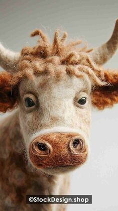 a close up of a stuffed cow's head with hair on its face and nose