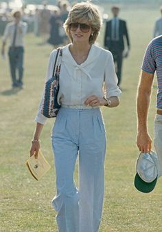 a man and woman walking in the grass