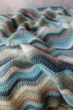 a crocheted blanket on top of a bed