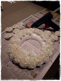 a wreath made out of flowers sitting on top of a newspaper