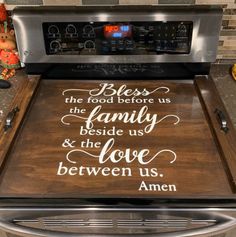 a kitchen stove with a sign on the burner that says, bless the food before us family beside us and the love between us