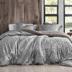 a leopard print comforter set on a bed