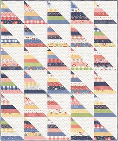 a quilt with many different colors and patterns on the front, along with a white background