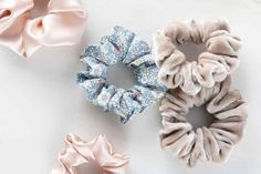 three scrunffle hair ties in various colors and patterns on a white surface with pink bows