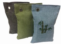 three pillows with palm trees on them and buttons in the middle one is green, the other two are blue