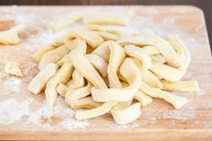 homemade egg noodles on a cutting board with text overlay that reads homemade egg noodles