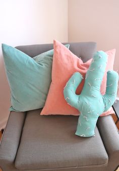 a couch with some pillows on it and a pillow in the shape of an elephant