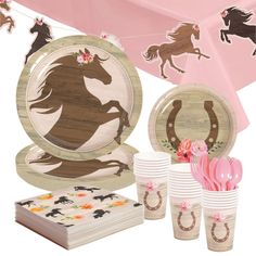 a table with plates, cups and napkins on it that include horse silhouettes