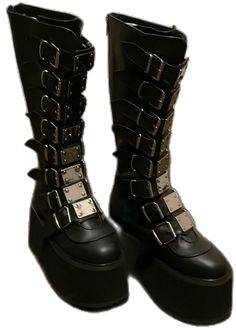 Black Knee-high Platform Moto Boots, Gothic Black Platform Boots With Buckle Closure, Black Gothic Platform Boots With Buckle Closure, Black Platform Boots With Buckle Closure, Black Closed Toe Platform Boots With Buckle, Black Closed Toe Platform Boots With Buckle Closure, Gothic Boots With Buckle Closure And Round Toe, Black High Ankle Boots With Metal Feet, Black High Ankle Boots With Metal Accents