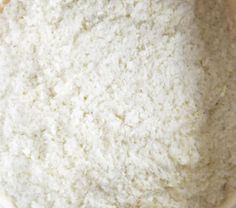 a bowl filled with white rice sitting on top of a table