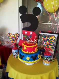 a mickey mouse birthday cake on a table