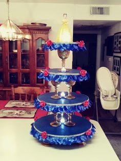 three tiered cake stand with red roses on it