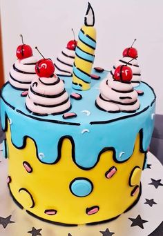 a blue and yellow birthday cake with cherries on top