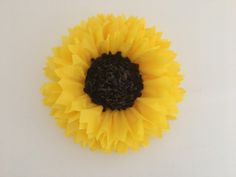 a sunflower is shown on a white surface