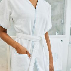 We shortened the sleeves, cropped the length, and nixed the collar to create this light (yet deeply fluffly) Summer sister of our classic Long Robe. Our short robe packs perfectly for a weekend away and works for hot weather and the hot-natured alike. This is going to be your new favorite short sleeve robe. Our favorite part? The attached tie that won’t fall off in the wash (and pockets, of course). Makeup Towel, Household Gifts, Terry Robe, Luxury Robes, Spa Headband, Spa Towels, Luxury Spa, One Hair, Womens Robes