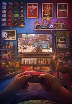 a person holding a video game controller in front of a tv with pictures on the wall