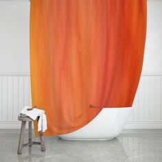 an orange and red shower curtain in a white bathroom with a stool next to it