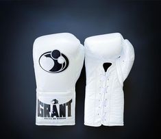 a pair of white boxing gloves on a black background