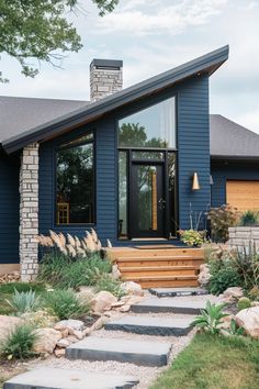 a blue house with steps leading to the front door