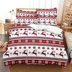 a bed covered in red and white christmas themed sheets