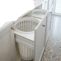 a laundry basket in the corner of a white cabinet next to a washer and dryer