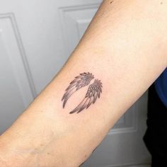 a person's arm with a small tattoo on the left side of their arm