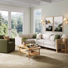 a living room with two couches and a coffee table in front of large windows