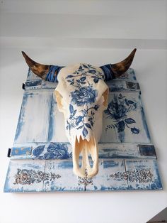 an animal skull mounted on the wall with blue and white tiles in it's center