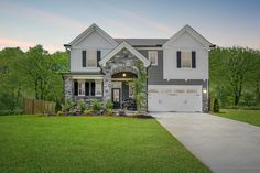 a large house with two garages in the front yard