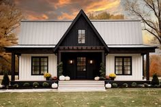 a black and white house with pumpkins on the front porch, and trees in the background