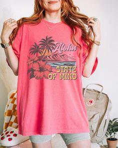 Aloha State of Mind, Aloha Tshirt, Aloha T Shirt, Aloha Shirt/Hawaii T Shirt/Beach Shirt/Vacation Shirts/Hawaii Gifts/Hawaiian Gifts/Summer Gifts Crafted from lightweight cotton that is perfect for active wear or leisure, our Aloha State of Mind shirt offers comfort and style. It's ideal for casual wear, whether going to work, grabbing coffee with friends, or just wanting to wear a comfortable shirt during daily activities. Whether you're curled up on the couch, on the beach, or simply lounging Beachy Short Sleeve Hawaiian Shirt For Spring, Pink Hawaiian Short Sleeve T-shirt, Summer Hawaiian Shirt For Surfing, Red Tropical Hawaiian Shirt For Beach Season, Tropical Print Short Sleeve T-shirt, Pink Hawaiian Camp Shirt For Beach, Hawaiian Short Sleeve Graphic Shirt, Casual Pink Hawaiian Shirt With Hibiscus Print, Summer Camp Shirt With Hibiscus Print For Beach