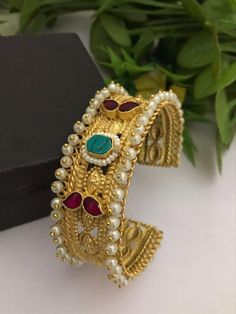 Material:  brass, Cz Stone, pearls  Stunning Gold Bracelet with Royal and Elegant look. You can wear this with any kind of outfits like Kurtis, lehanga, Sarees and Trousers and Denims. Most eligible gift for someone you love and someone very special for you. Best gift for your anniversary. Best gift for her Birthday. Bracelet : 1 Arrives in a small plastic box. For any queries please contact me. Gold Pearl Bracelet With Intricate Design For Wedding, Pearl Bangle Bracelet For Festivals As Gift, Heavy Fusion Style Bracelets For Celebration, Heavy Fusion Style Bracelet For Celebration, Festive Gold Pearl Bracelet Gift, Temple Jewelry Brass Bracelets For Wedding, Traditional Gold Bangle Pearl Bracelet, Kundan Chandbali Bracelets For Gifts, Traditional Gold Pearl Bangle Bracelet