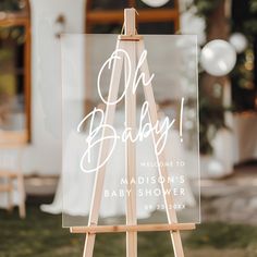 an easel with a sign that says oh baby on it