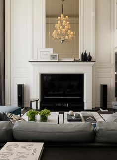 a living room filled with furniture and a fire place next to a tv mounted on a wall