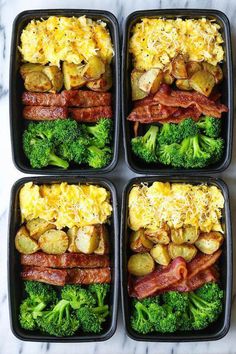 four trays filled with different types of food on top of a marble countertop