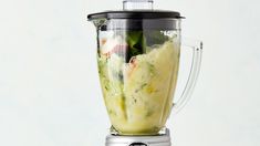 a blender filled with food on top of a table